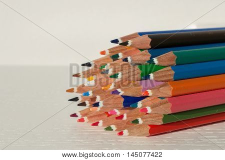 Sharp colorful crayons grouped as a bunch