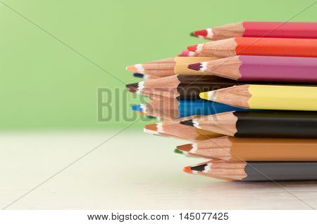 Sharp colorful crayons grouped as a bunch