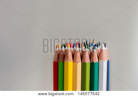 Sharp colorful crayons grouped as a bunch