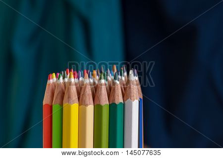Sharp colorful crayons displayed in various ways