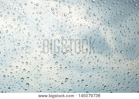 raindrops flowing through glas, closeup texture water