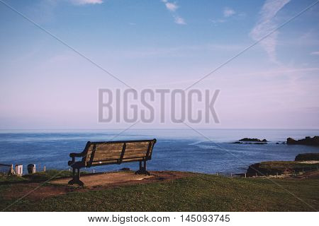 Empty Bench Over Looking The Coast In Bude, Cornwall Vintage Retro Filter.
