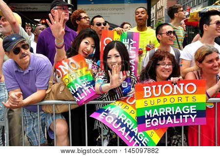 New York City - June 29 2013: Spectators holding Barbara Buono Marriage Equality signs at the 2013 Gay Pride Parade on Fifth Avenue
