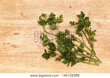 A bunch of green parsley on a wood table