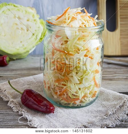 Pickled cabbage with carrots and red hot peppers selective focuc