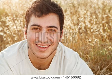 Happy man smiling in a beautiful field