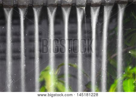 Blur blurred Motion drop of water rain from roof at  reflex  light  night . soft focus  with copy space Ideal use for background