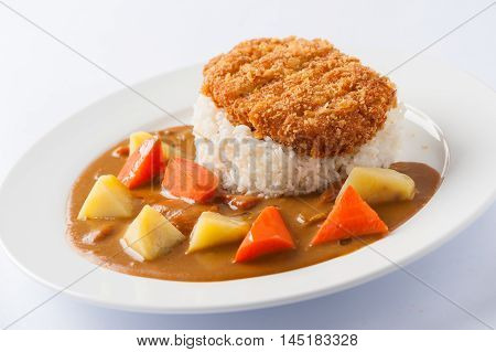 Japanese cuisine rice with deep fried pork and curry sauce with potatoes and carrots in ceramic dish