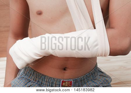 gauze bandage elastic. Pain and injury concept. Young man holds bandaged hand. Injured part of body. Medicine and healthcare.