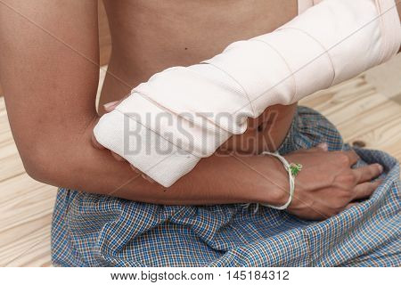 gauze bandage elastic. Pain and injury concept. Young man holds bandaged hand. Injured part of body. Medicine and healthcare.