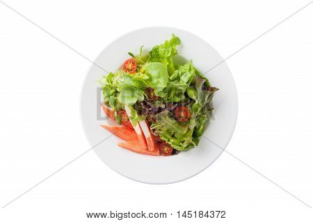 Top view of Modern Japanese style salad with crab stick in ceramic dish isolated on white background