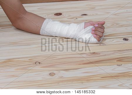 Gauze bandage the hand contusion. treating patients with hand with a wrist left male With  wrapping his injury On a wooden table
