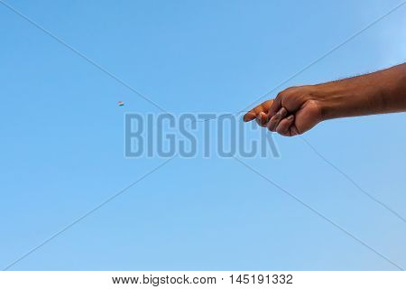 Kite Indian flag in blue sky with hand