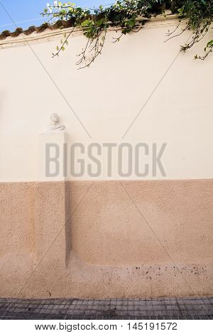 PALMA DE MALLORCA BALEARIC ISLANDS SPAIN - APRIL 4 2016: Stone wall with bust in El Terreno on April 4 2016 in Palma de Mallorca Balearic islands Spain.