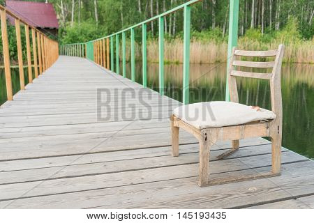 Wooden chair on the pier at Alabuga lake