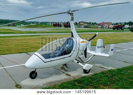 Tyumen, Russia - June 24, 2016: The 5th open championship of Russia on a plowed land. AutoGyro Europe Calidus helicopter stands on road