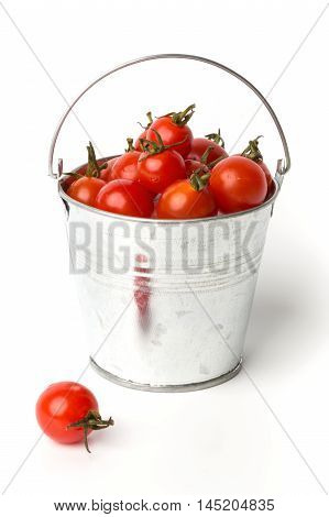 Fresh tomatoes in a pail isolated on white background