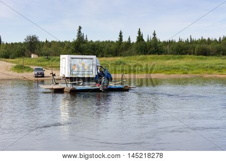 Borovskaya Russia - 25.07.2016: transporting cars throw the river Pizhma on handmade ferryboat