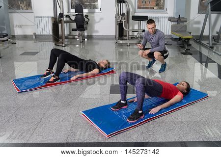 People Stretching During Fitness Class In Fitness Center