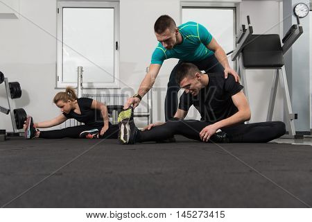 People Stretching During Fitness Class In Fitness Center