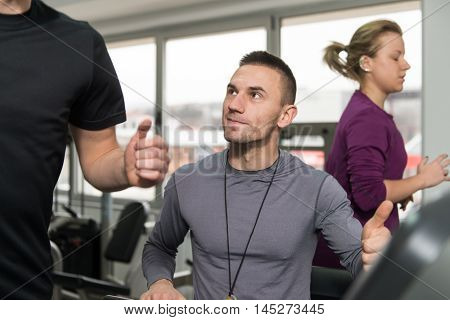 Group Of People Running On Treadmills In Gym