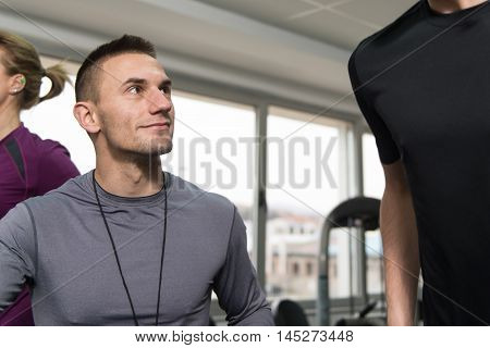 Group Of People Running On Treadmills In Gym