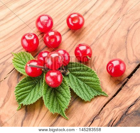 Nanking or felted cherry ftuits with leaves on the wooden table.