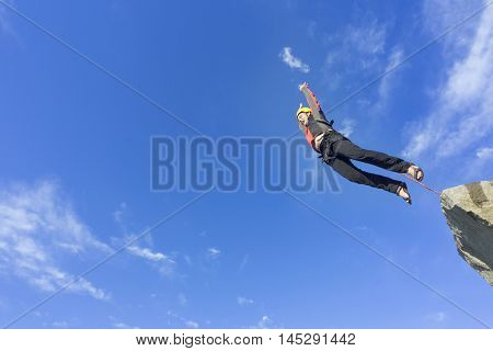 The first jump off the cliff with a safety rope.