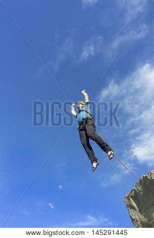 The first jump off the cliff with a safety rope.