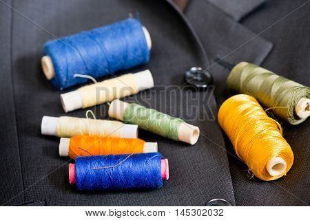 sewing kit on the gray mans jacket