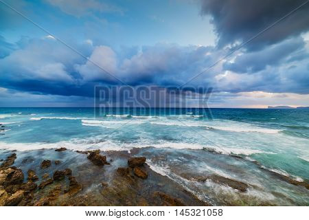 dramatic sky over Alghero coastline at sunset Sardinia
