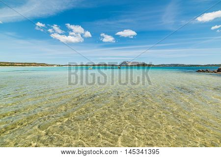 white clouds over Cala Brandinchi in Sardinia