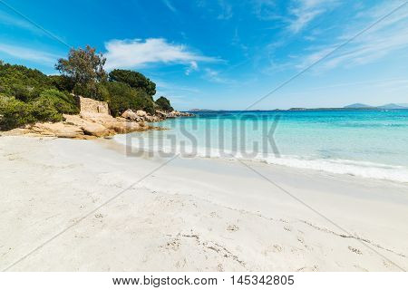 rocks and sand in Capriccioli beach Sardinia