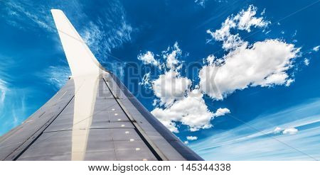 an aiplane wing in the blue sky