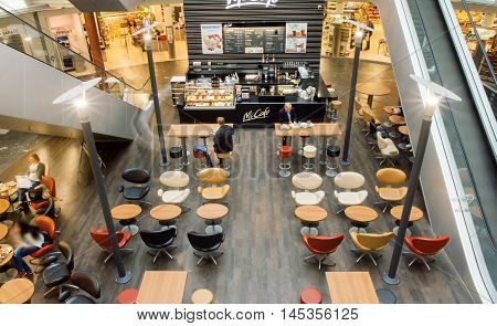 VIENNA, AUSTRIA - JUN 6, 2013: Interior of city cafe inside the moderm shopping mall with customers on June 6, 2013. Vienna city has population near 1.8 million