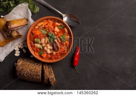 Rustic Kidney Bean Soup with beans and carrot. On the black chalkboard
