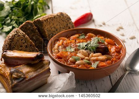 Rustic Kidney Bean Soup with beans and carrot. On the white wooden table