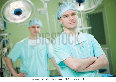male cardiac surgeon at child cardiosurgery operating room