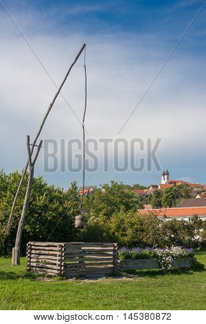 Tihany Abbey with a traditional old hungarian well (shadoof) at Lake Balaton Hungary