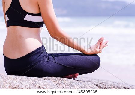 Yoga woman meditating and making a zen symbol with her hand