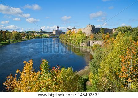 Sunny september day on the border river Narva. Look at the Russian Ivangorod fortress and the Estonian Hermann castle