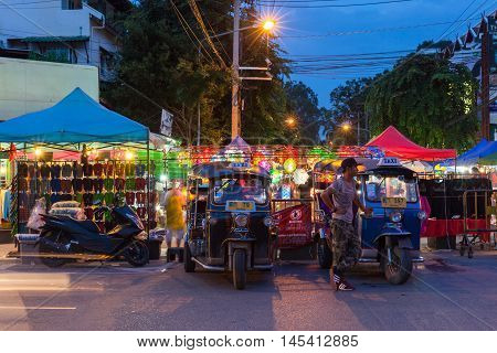 CHIANG MAI THAILAND - AUGUST 21: Tuk-tuk taxis wait for customers near Saturday Night Market on August 21 2016 in Chiang Mai Thailand.