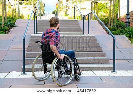 Disabled Man In Wheelchair In Front Of Stairs