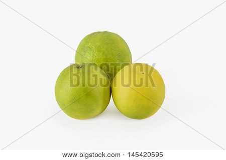 Three sweet lime (sweet limetta) fruits on a white background