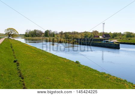 Small river Pakalne reflects blue sky rusne island lithuania