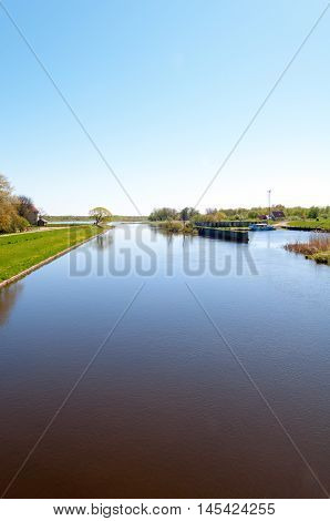 Small river Pakalne reflects blue sky rusne island lithuania