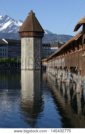LUCERNE SWITZERLAND - MAY 05 2016: View towards the octagonal tall tower (Wasserturm) together with the Chapel Bridge (Kapellbruecke) it is one of the Lucerne's most famous tourists attraction