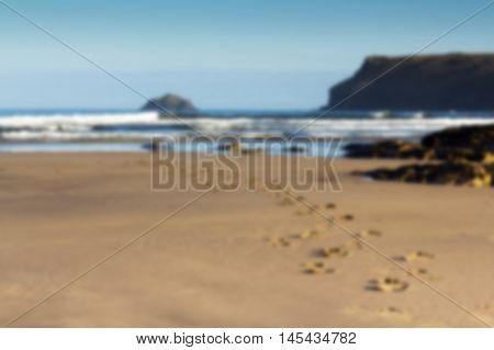Footprints In The Sand On Polzeath Beach Out Of Focus.
