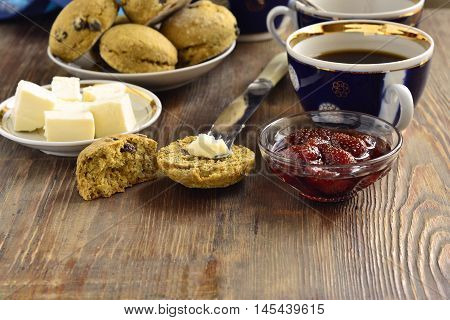Pumpkin scones with dried fruit for breakfast served with jam and butter