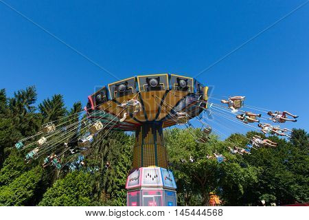 Biddinghuizen, The Netherlands - August 24, 2016: High speed carousel with park visitors during a ride at Walibi theme park.